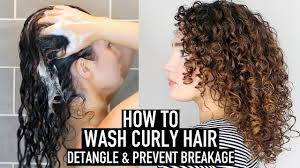"Curly-haired woman applying sulfate-free shampoo for defined, frizz-free curls—essential for proper curly hair care."